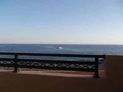 a view of the ocean with a boat in the water at Kritamos Beach Apartments in Frangokastello
