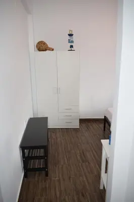 a living room with a table and a cabinet at Panorama Sea View Apartment in Beritianá