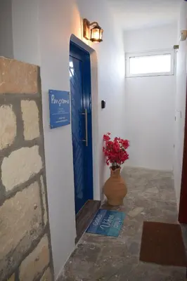 a blue door with a vase of flowers in aoyer at Panorama Sea View Apartment in Beritianá