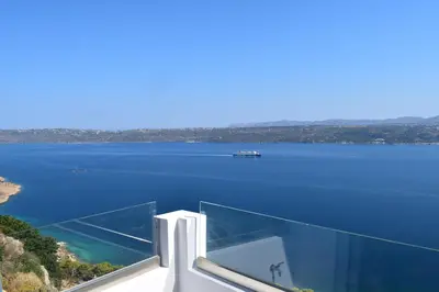 a glass house with a view of a body of water at Panorama Sea View Apartment in Beritianá