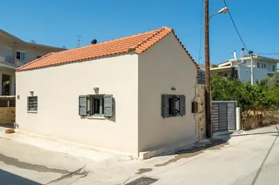 a small white house with a red roof at The Violin House in Chania Town