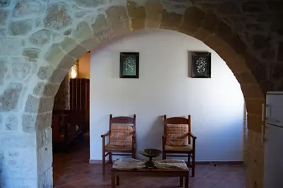 an archway in a house with two chairs and a table at VILLA MICHAELA in Gramvousá