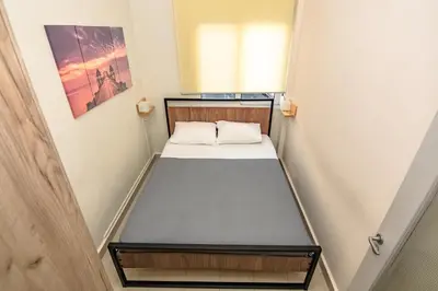a small room with a bed in it at PLUS 2! in Chania Town
