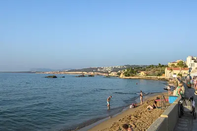 a group of people on a beach near the water at PLUS 2! in Chania Town
