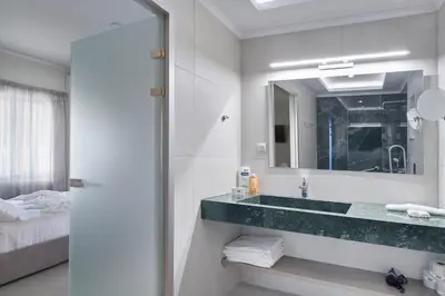 a bathroom with a sink and a mirror at El Platanias in Chania Town