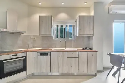 a kitchen with wooden cabinets and a sink at El Platanias in Chania Town