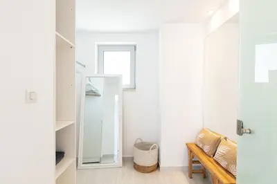 a dressing room with a mirror and a bench at Vista Residence in Chania Town