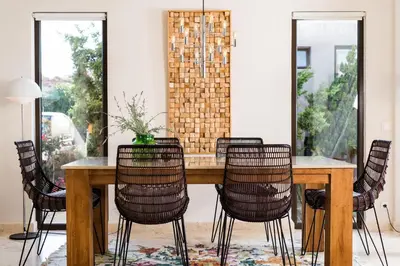 a dining room with a wooden table and chairs at Magnifique villa avec piscine au bord de mer in Chorafakia