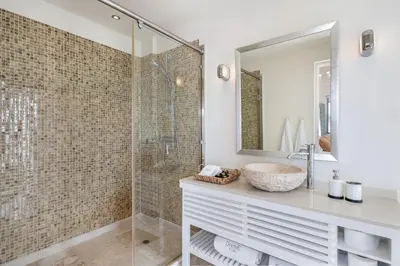 a bathroom with a sink and a shower at Magnifique villa avec piscine au bord de mer in Chorafakia