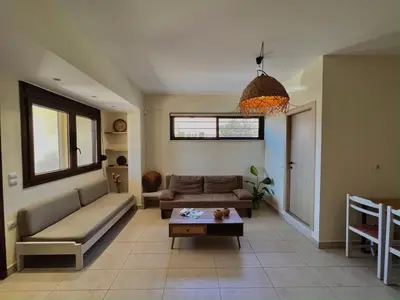 a living room with a couch and a table at Solis Occasum in Aghii Apostoli