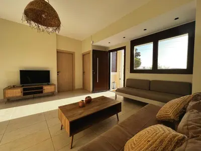a living room with a couch and a coffee table at Solis Occasum in Aghii Apostoli