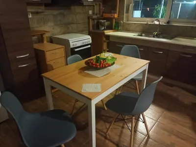 a kitchen with a table with chairs and a bowl of fruit on it at Amazing View in Kissamos