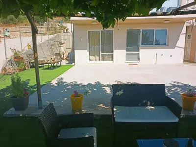 a patio with two chairs and a table in a yard at Amazing View in Kissamos
