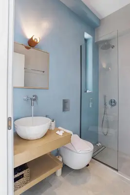 a bathroom with a sink and a toilet and a shower at Annassa Experience Villa 2' walk from Almyrida beach in Almirida