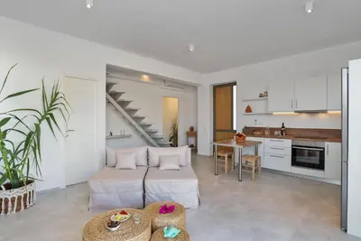 a living room with a bed and a kitchen at Annassa Experience Villa 2' walk from Almyrida beach in Almirida