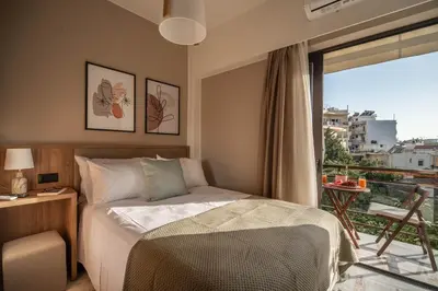 a bedroom with a bed and a balcony with a view at Cretan Sea View Apt 8mins to beach,old town, city in Chania Town