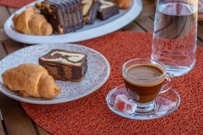 a table with plates of pastries and a cup of coffee at Cretan Sea View Apt 8mins to beach,old town, city in Chania Town
