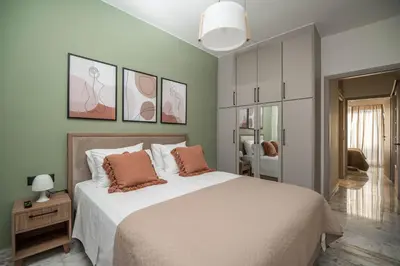 a bedroom with a large bed with two pillows on it at Cretan Sea View Apt 8mins to beach,old town, city in Chania Town