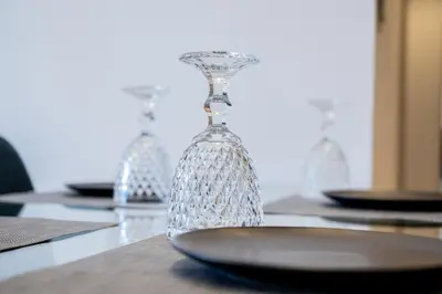 a glass vase sitting on a table with a plate at Yiannis Deluxe Apartment in Chania Town