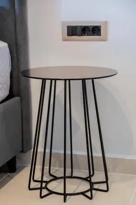 a round black table in a room with a couch at Yiannis Deluxe Apartment in Chania Town