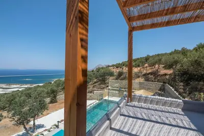 a view of the ocean from the balcony of a house at Alma Natura Villas Falasarna- Avgerinos Villa in Falasarna
