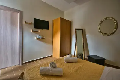 a bedroom with a bed with two towels on it at West Crete House in Kámbos