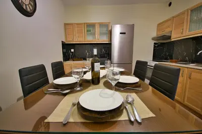 a dining room table with a bottle of wine and glasses at West Crete House in Kámbos