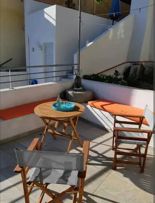 a table and two chairs and a table and chairs at Orea Kaliva in Sfinárion
