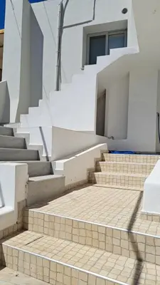 a set of stairs in a building with a window at Orea Kaliva in Sfinárion