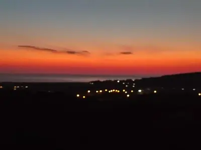 a sunset view of a city with lights at Anatolika Stamatis Paradise in Dhémbla