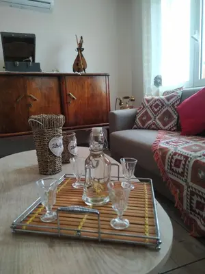 a living room with a tray of glasses on a table at Chrisi Traditional House in Néon Khoríon