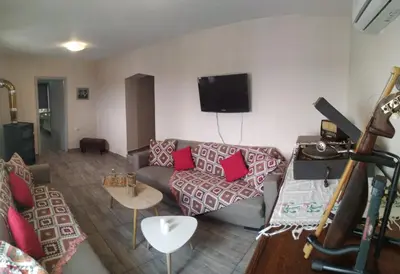 a living room with a couch and a tv at Chrisi Traditional House in Néon Khoríon