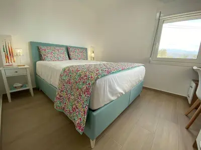 a bedroom with a bed and a window at MAGIC VIEW APARTMENT in Chania Town