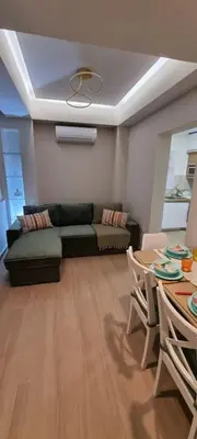 a living room with a couch and a table at MAGIC VIEW APARTMENT in Chania Town