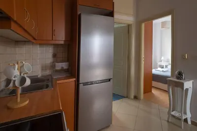 a kitchen with a stainless steel refrigerator in a kitchen at NEFELI APARTMENT CHANIA in Chania Town