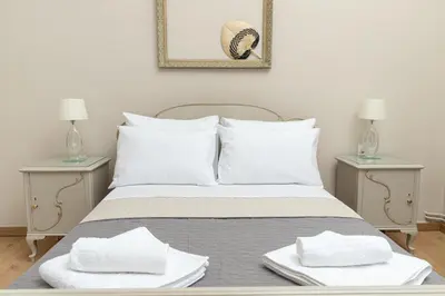 a bedroom with a bed with two side tables at Πλήρως ανακαινισμένη μονοκατοικία. in Chania Town