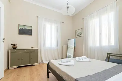 a bedroom with a bed and a dresser and a mirror at Πλήρως ανακαινισμένη μονοκατοικία. in Chania Town