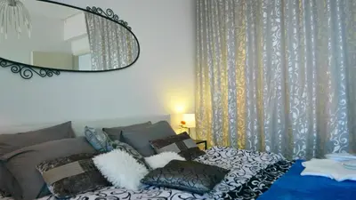 a bedroom with a bed with a large mirror at Elpida Seafront Paradise apartment in Crete in Chania Town