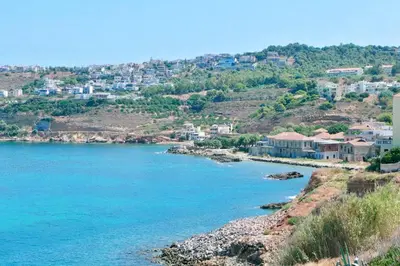 a view of a bay with houses on a hill at Elpida Seafront Paradise apartment in Crete in Chania Town
