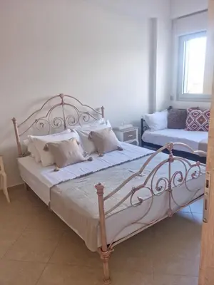 a bedroom with a large bed with white sheets and pillows at Villa Vanessa in Kissamos