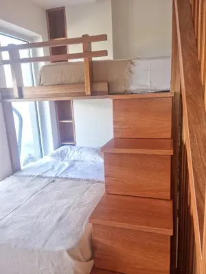 a bedroom with a bunk bed and a stairwell with a bed at Villa Vanessa in Kissamos