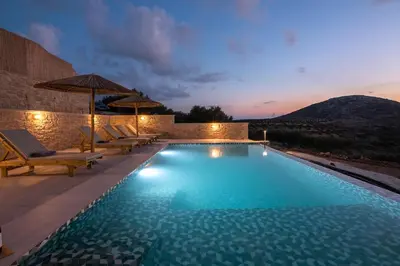 a pool with chairs and umbrellas at a resort at Alma Natura Villas Falasarna - Aposperitis Villa in Falasarna