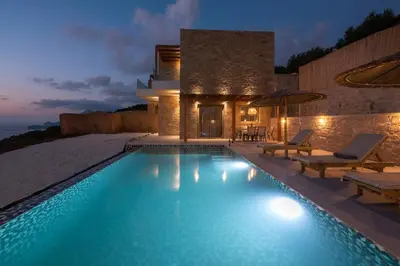 a villa with a swimming pool at night at Alma Natura Villas Falasarna - Aposperitis Villa in Falasarna