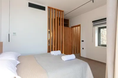 a bedroom with a bed with two towels on it at Villa Anasa in Palaiochóra