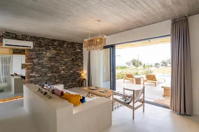 a living room with a couch and a table at Akra Grammeno Beachfront Villas in Palaiochóra