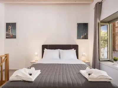 a bedroom with a large bed with two towels on it at Vaggelis house in Chania Town