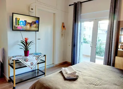 a bedroom with a bed and a table with a tv at Argy Cozy Apartment (Όμορφο Διαμέρισμα στα Χανιά) in Chania Town
