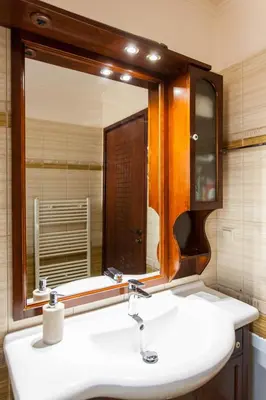 a bathroom with a sink and a mirror at Sounds Of The Mountain Chania in Varípetron