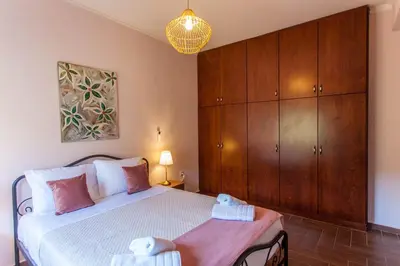 a bedroom with a bed with two towels on it at Sounds Of The Mountain Chania in Varípetron