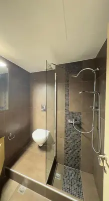 a bathroom with a toilet and a glass shower at Alendra's City Center Studio in Chania Town